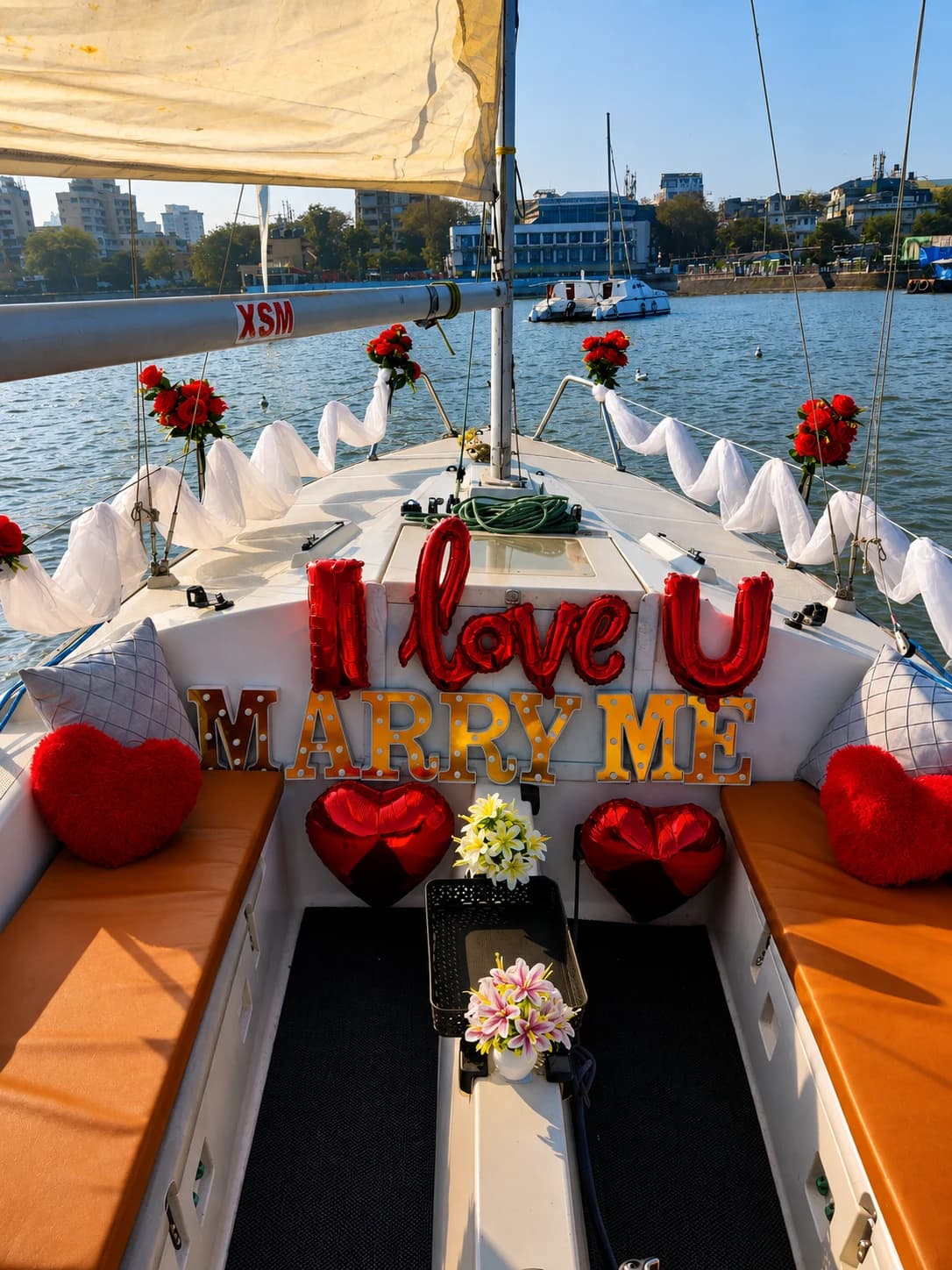 A proposal set-up on the bow reading I Love U, Marry Me, with the city skyline behind