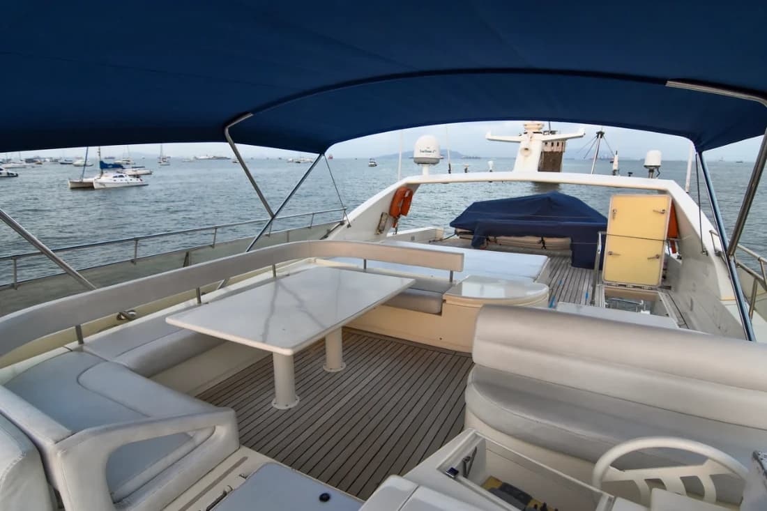 Flybridge bow sun pad seating with the Mumbai skyline behind