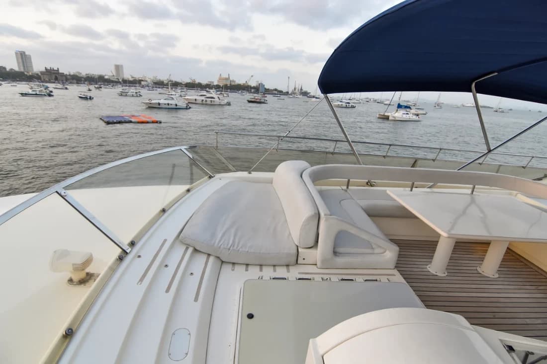 View from the flybridge sun pad over the crowded harbour and the Gateway of India at dusk