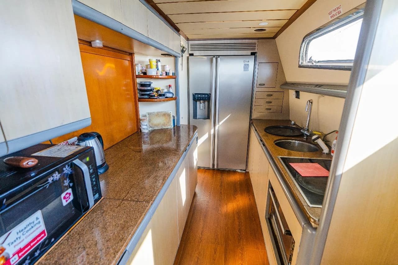 Allegra's galley, with a full-size fridge, sink and stovetop