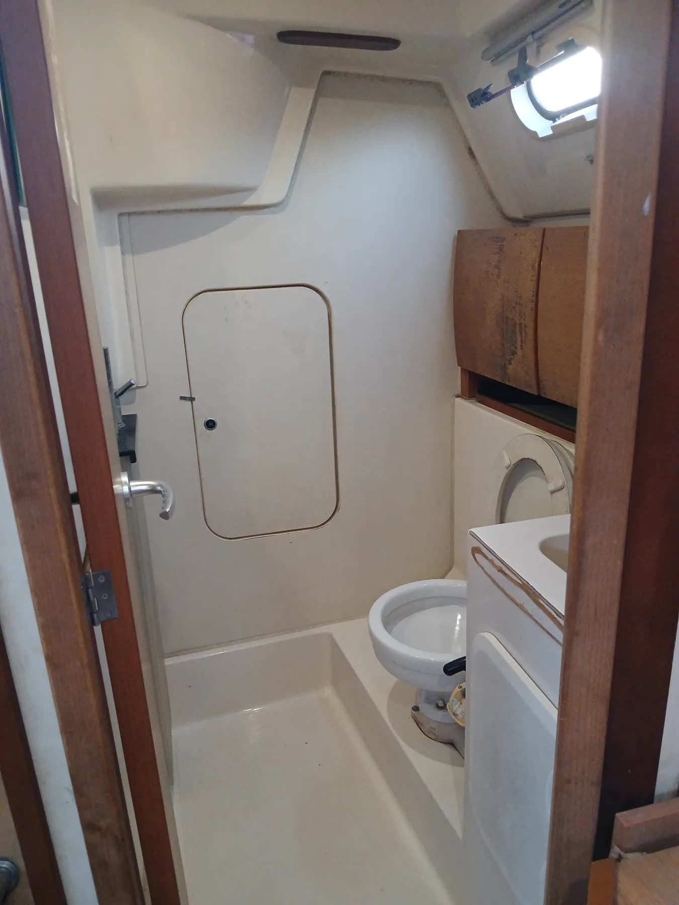 The head, with a toilet, sink and shower space