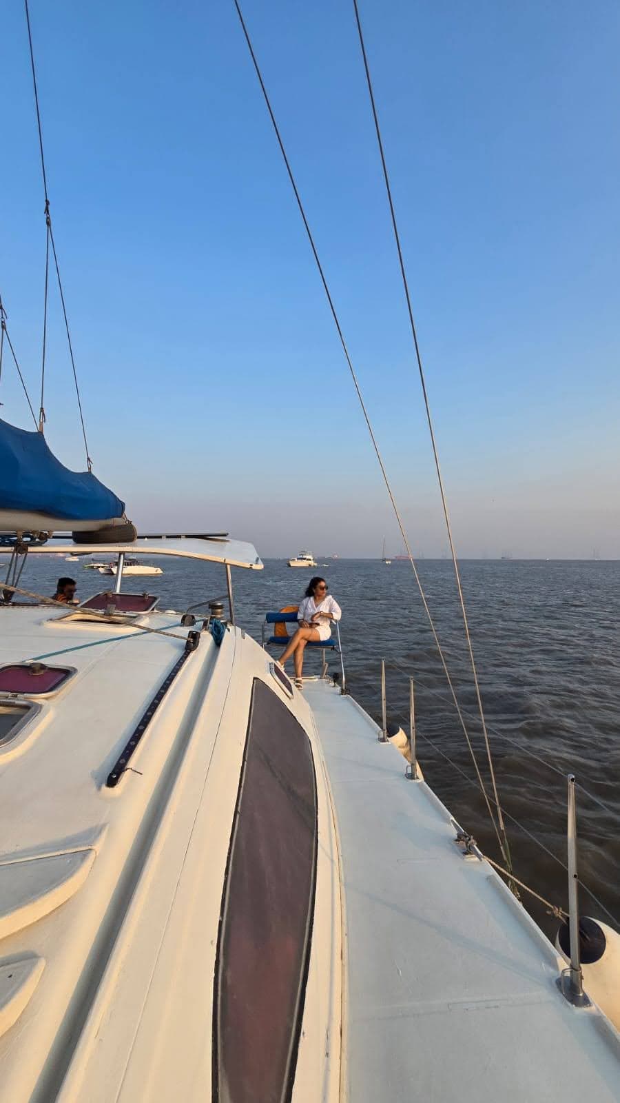 A guest relaxing on the aft deck seat as the sun gets low