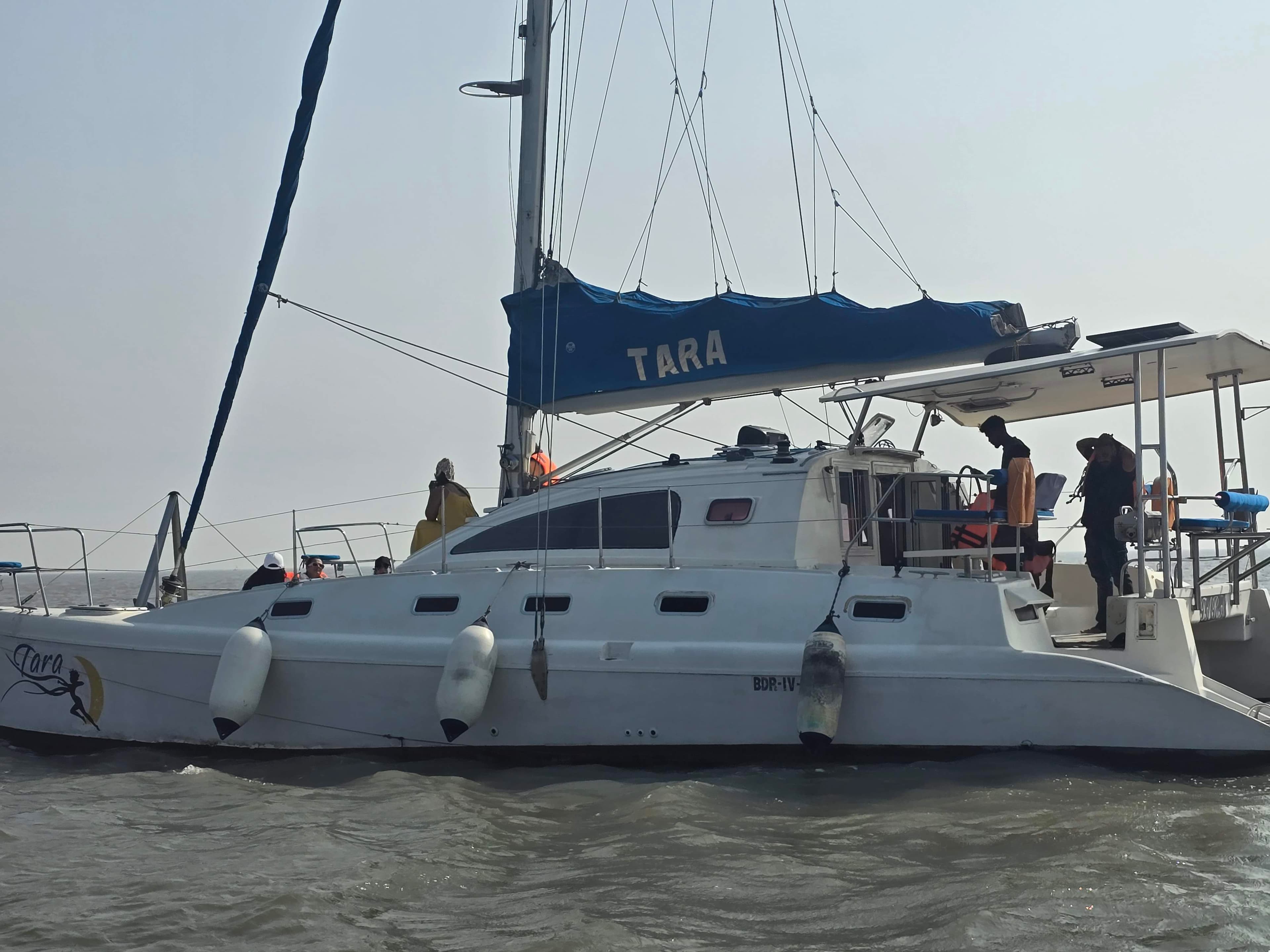 Tara's twin hulls and fenders viewed from alongside at the mooring
