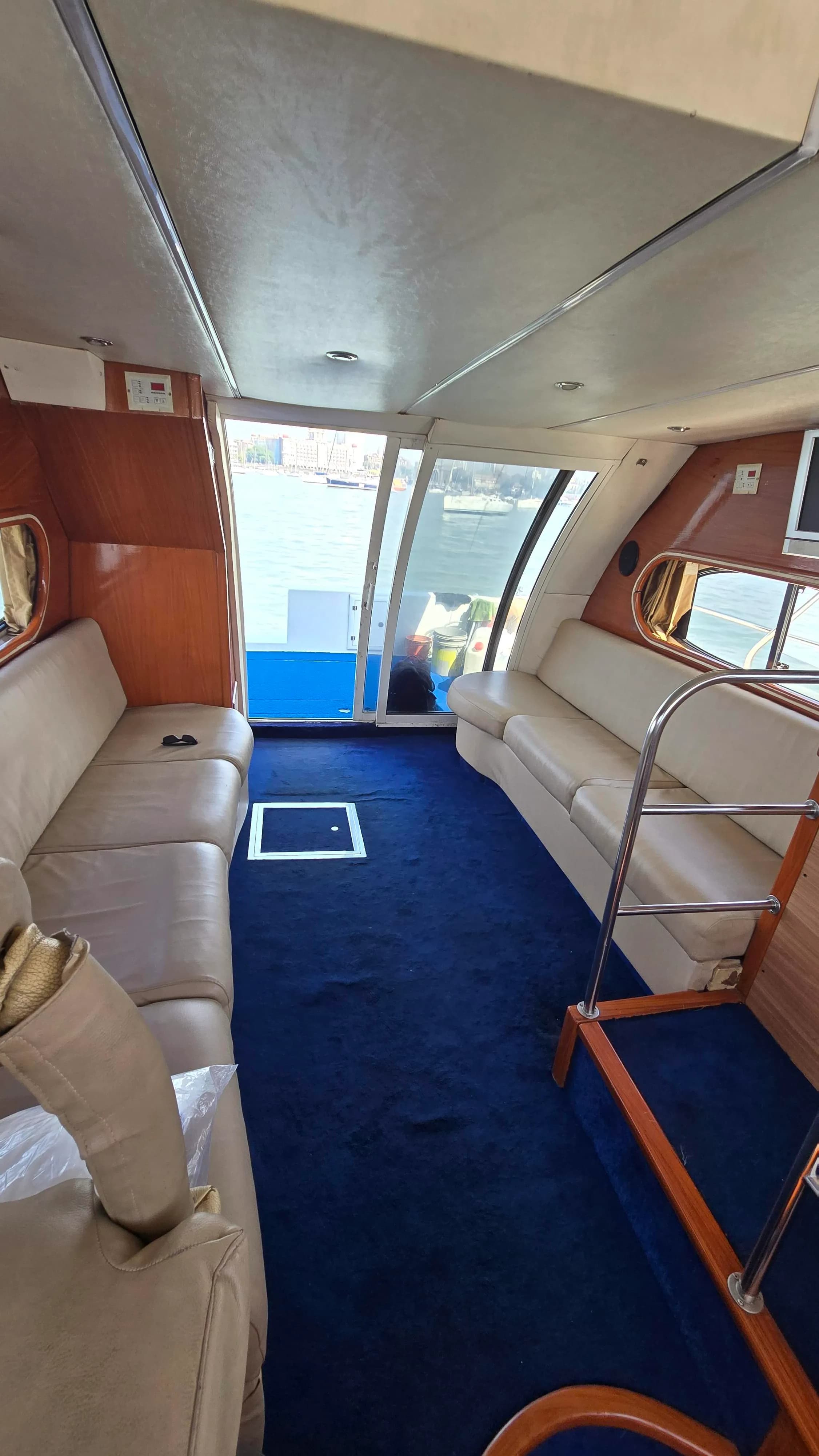 The saloon looking out through the aft doorway toward the city and moored boats
